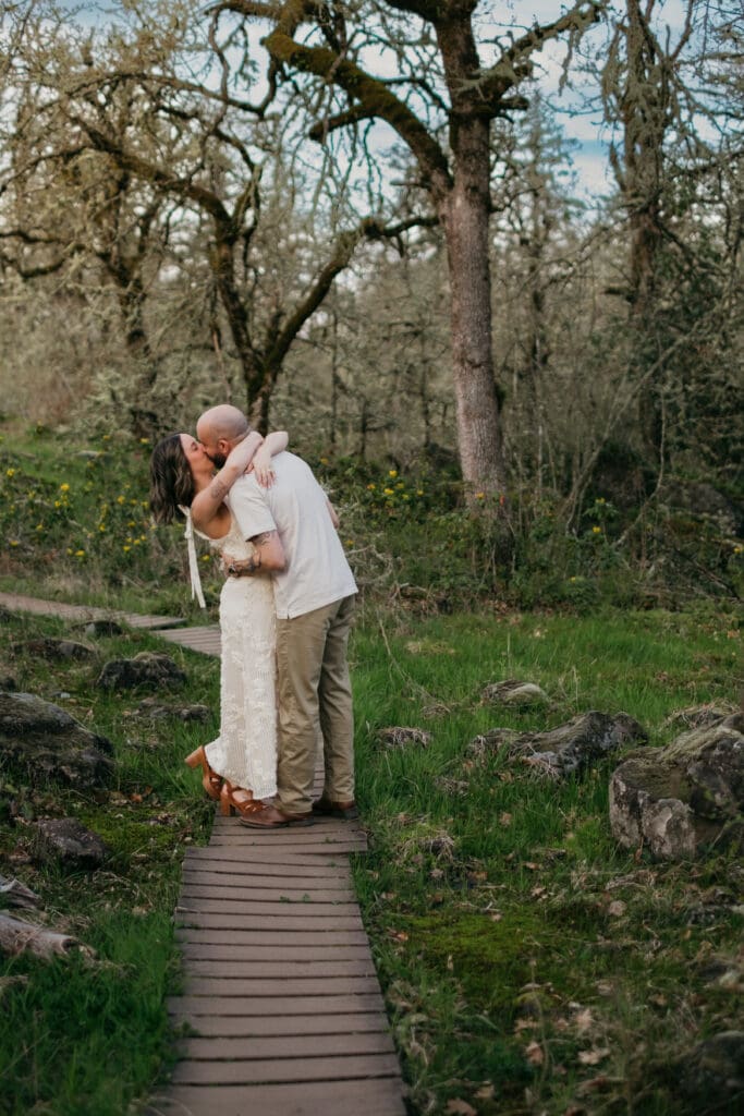A couple kissing on a pathway