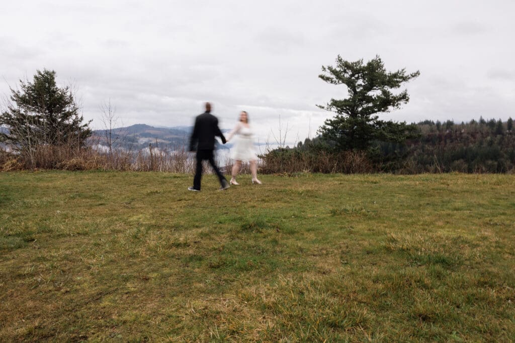 Couple posing together on cliffside at Portland Women’s Forum State Scenic Viewpoint in Corbett, Oregon.