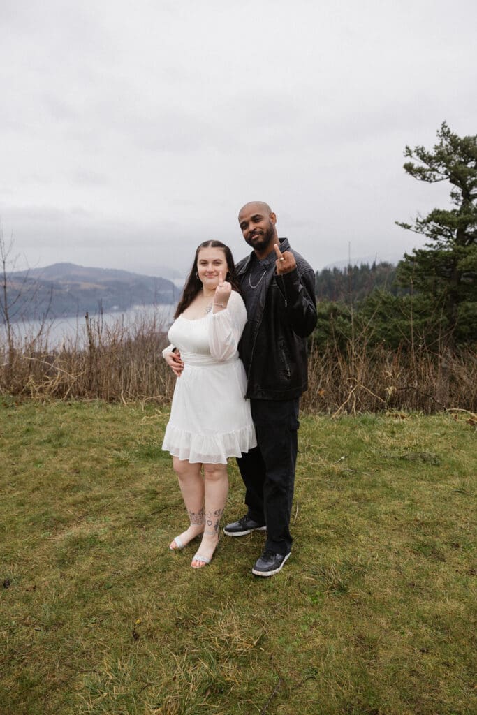 Couple posing together on cliffside at Portland Women’s Forum State Scenic Viewpoint in Corbett, Oregon.