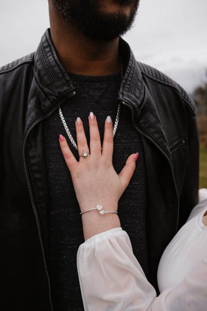 Close-up of engagement ring and bracelet against leather jacket at Portland Women’s Forum State Scenic Viewpoint in Corbett, Oregon.