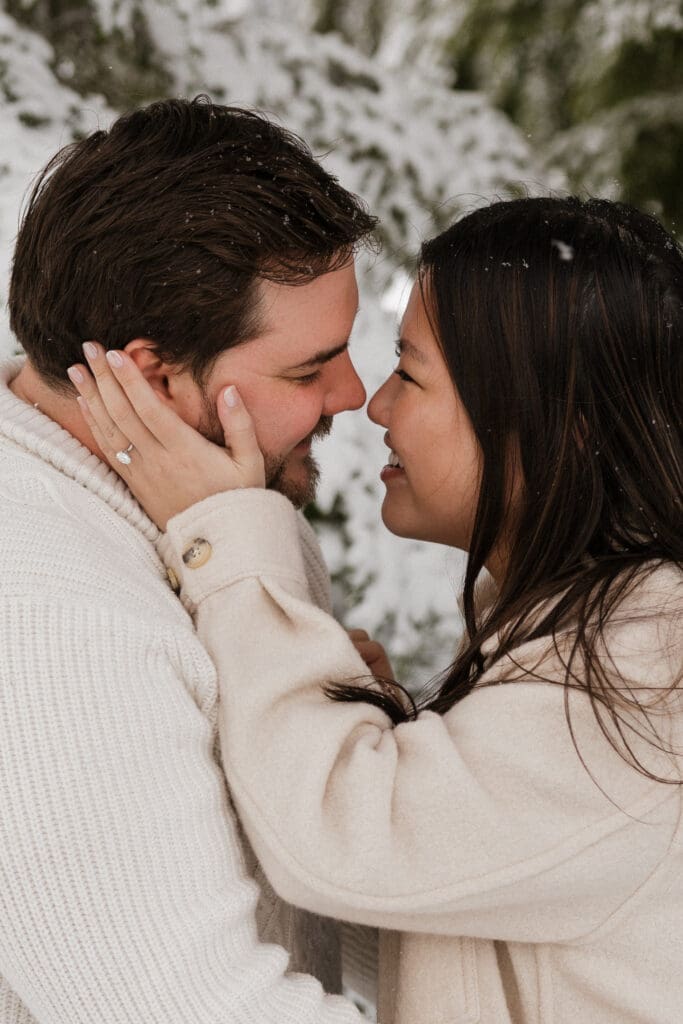 Close-up portrait of engaged couple smiling together in the snow near Mount Hood in Oregon