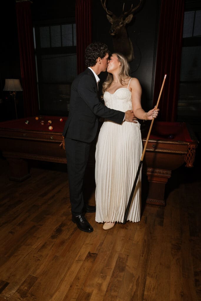 Couple kissing beside a pool table at The Arc Light in Oregon City, Oregon