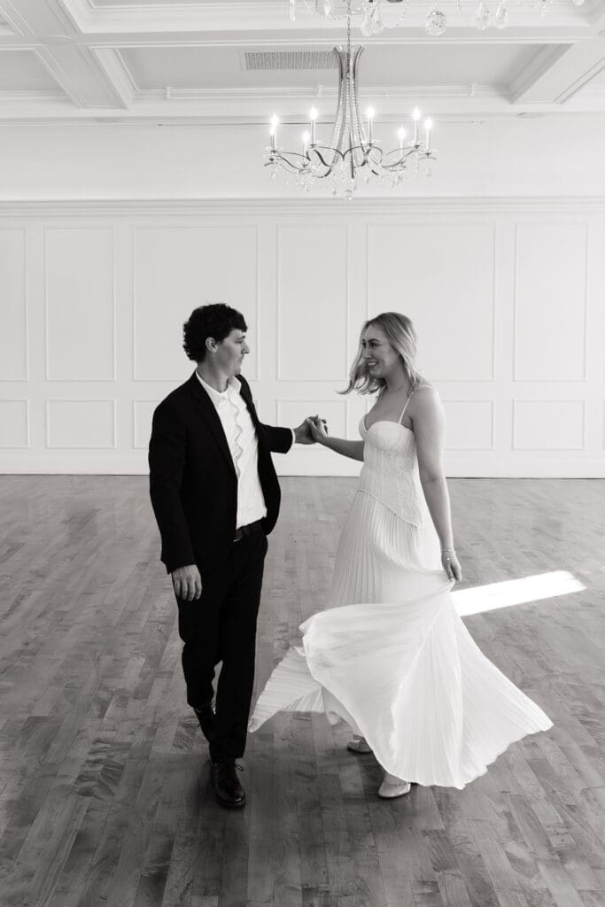 Black and white engagement photo of couple dancing at The Arc Light in Oregon City, Oregon