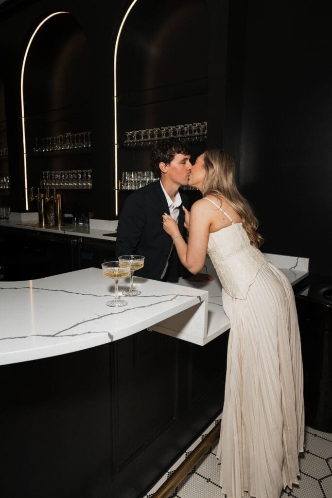 Couple kissing at cocktail bar during engagement session at The Arc Light in Oregon City, Oregon