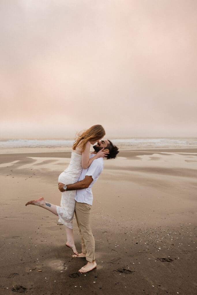 Couple hugging on the Oregon coast for Pacific City, Oregon elopement planning inspiration