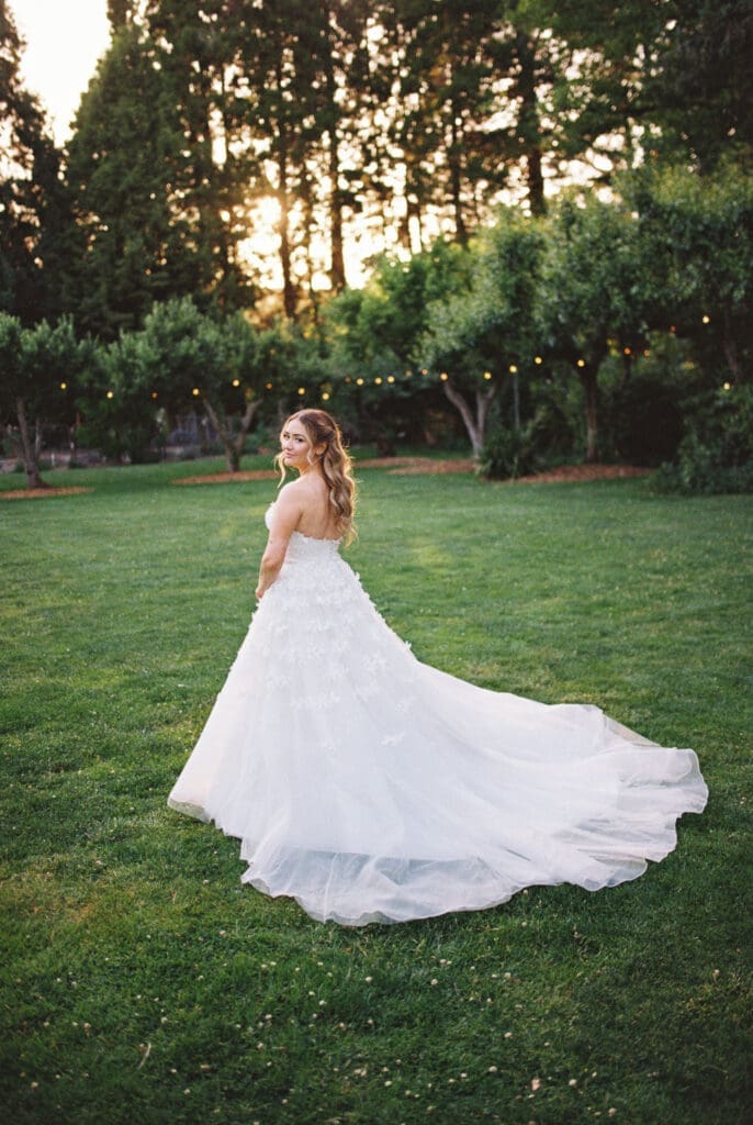Bride wearing a flowing wedding gown during golden hour at McMenamins Cornelius Pass Roadhouse in Hillsboro, Oregon.