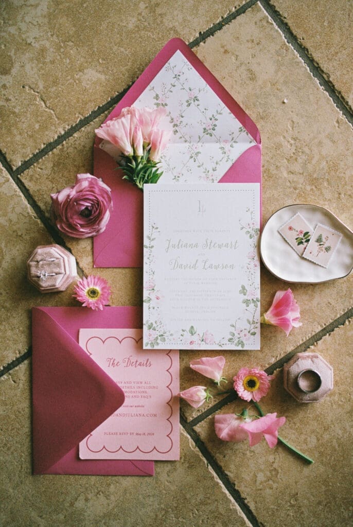 Floral wedding invitation suite with pink envelopes and rings photographed on film at Black Walnut Inn & Vineyard in Dundee, Oregon.