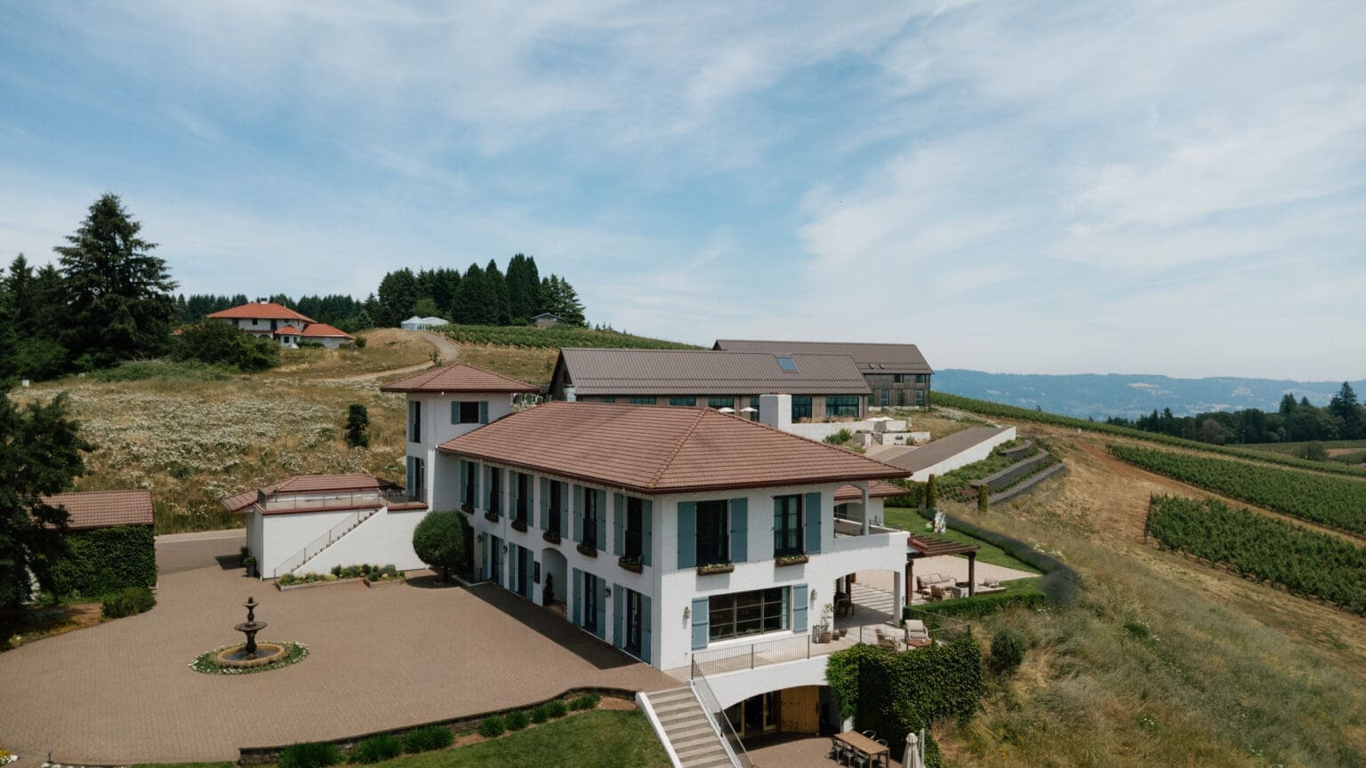 Black Walnut Inn overlooking vineyard-covered hills in Dundee, Oregon with expansive Willamette Valley views.