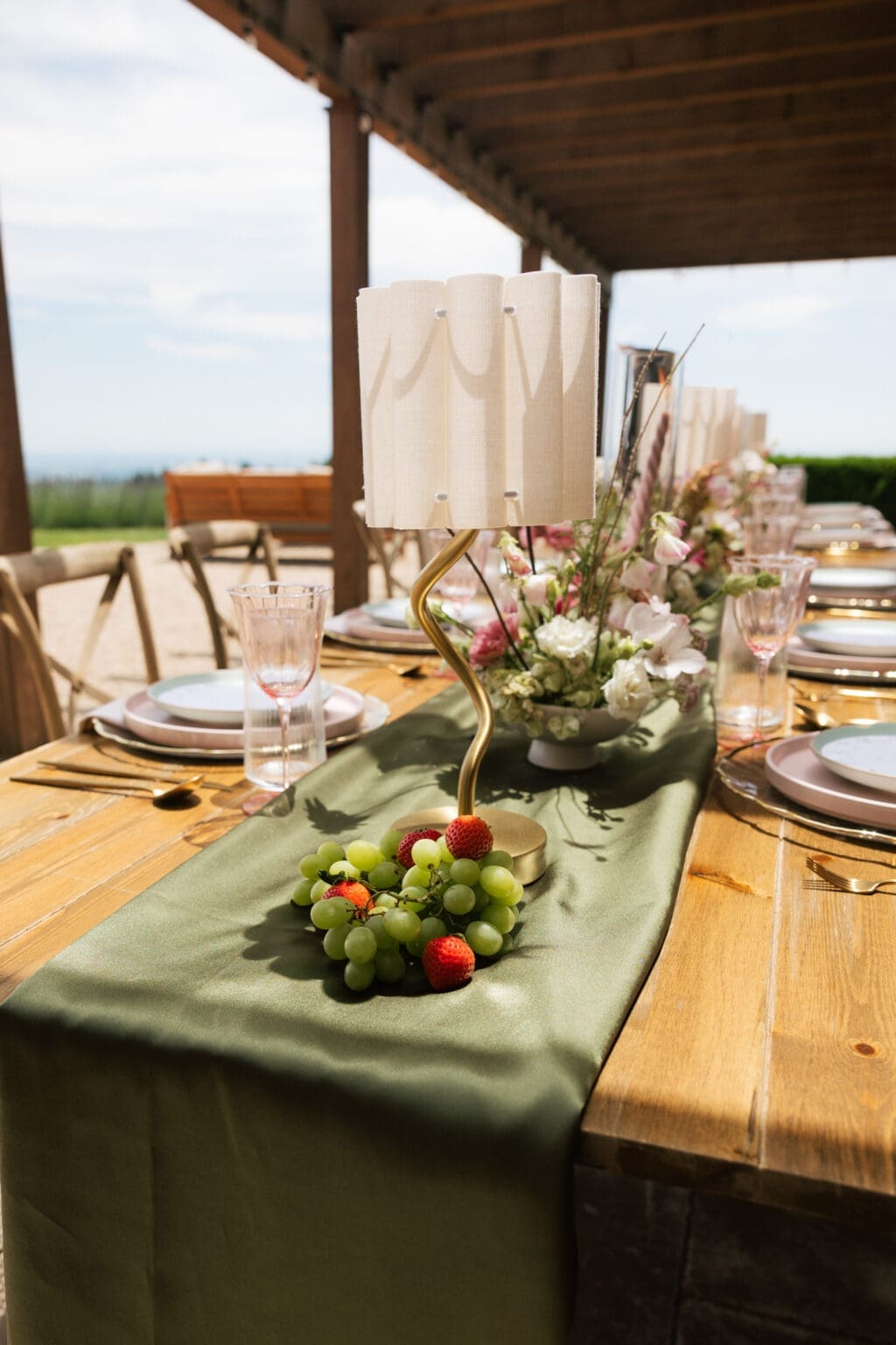 Wedding reception centerpiece with grapes, florals, and green runner at Black Walnut Inn in Dundee, Oregon.