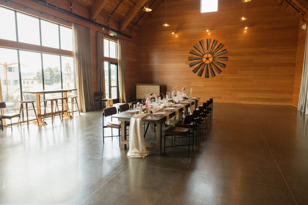 Reception table styled inside the event hall at Black Walnut Inn in Dundee, Oregon with modern floral decor.