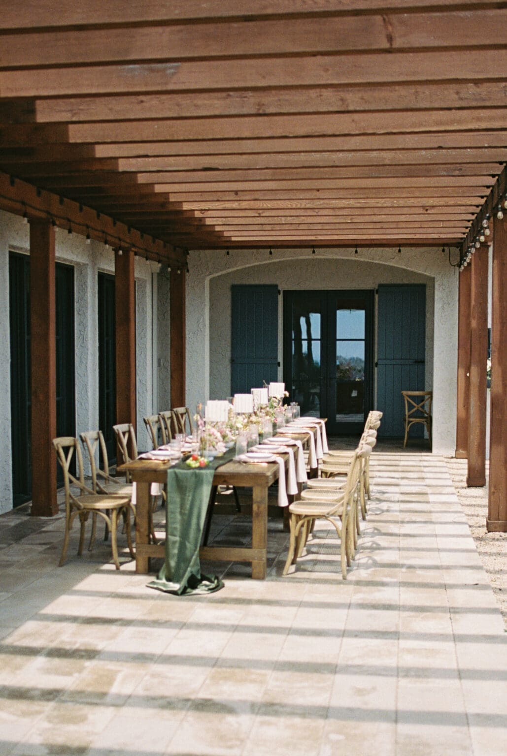 Film photograph of an outdoor reception table beneath the pergola at Black Walnut Inn in Dundee, Oregon.