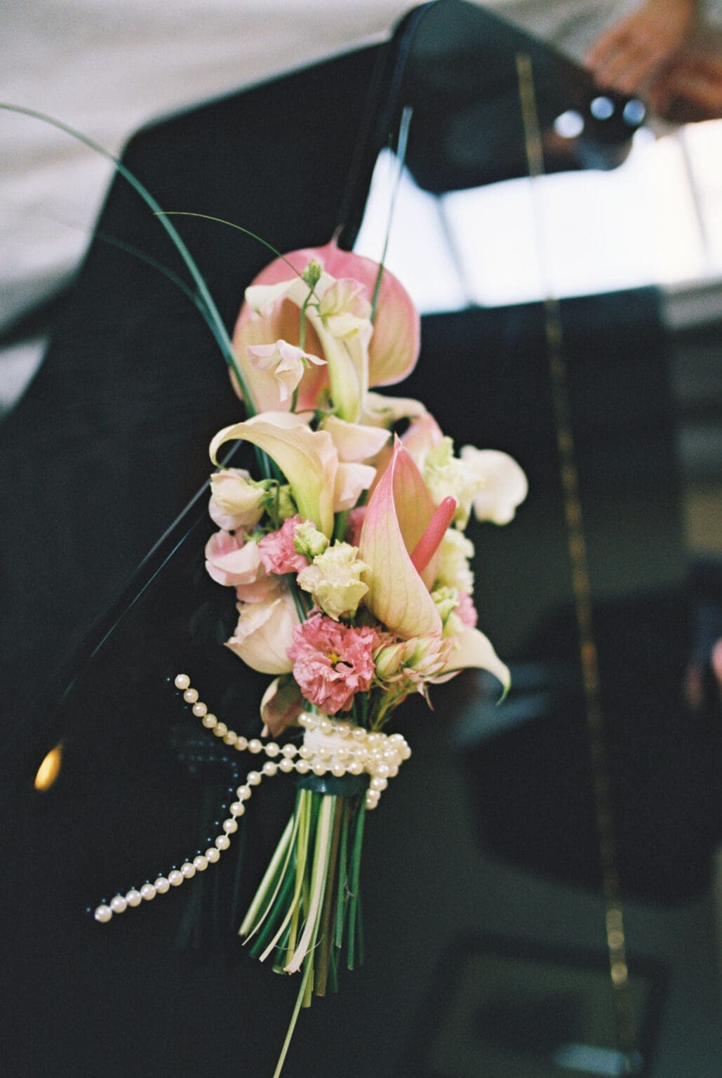 Film photograph of a bridal bouquet resting on a grand piano at Black Walnut Inn in Dundee, Oregon.